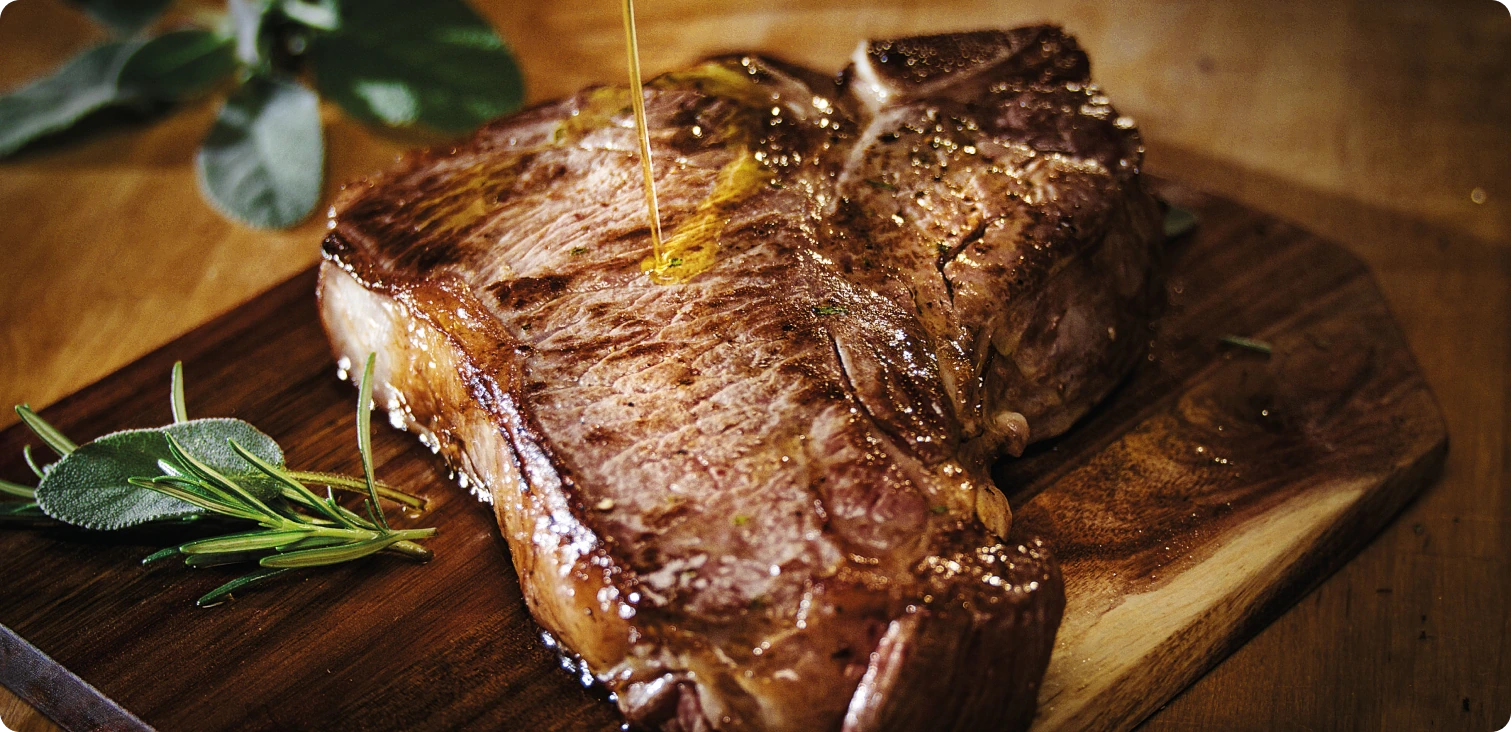 Olive oil drizzled over a grilled steak