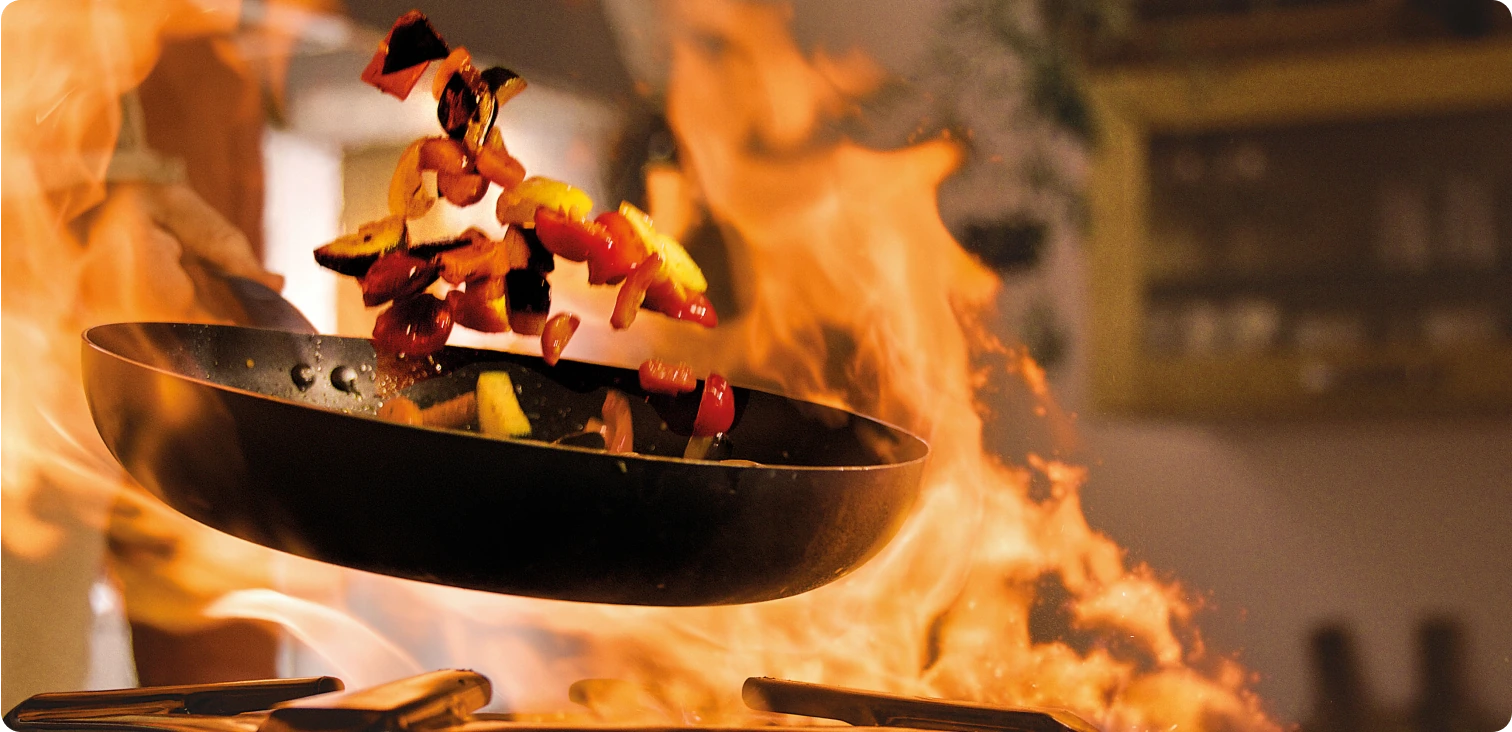 Vegetables tossed in a hot frying pan